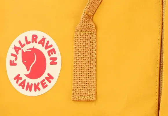 Close-up of Yellow Kanken Backpack Logo and Strap