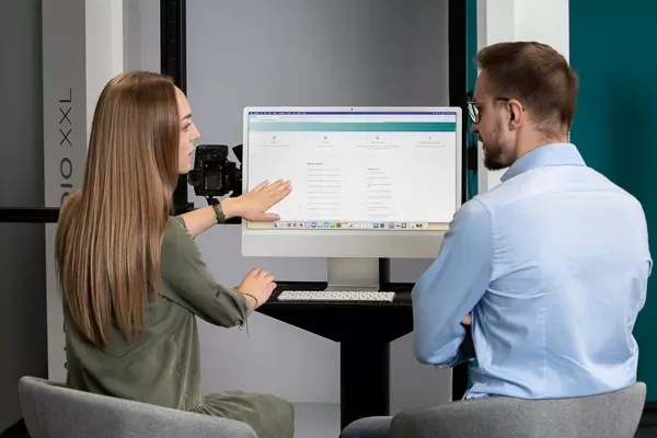  Two Colleagues Reviewing Software on Computer Monitor