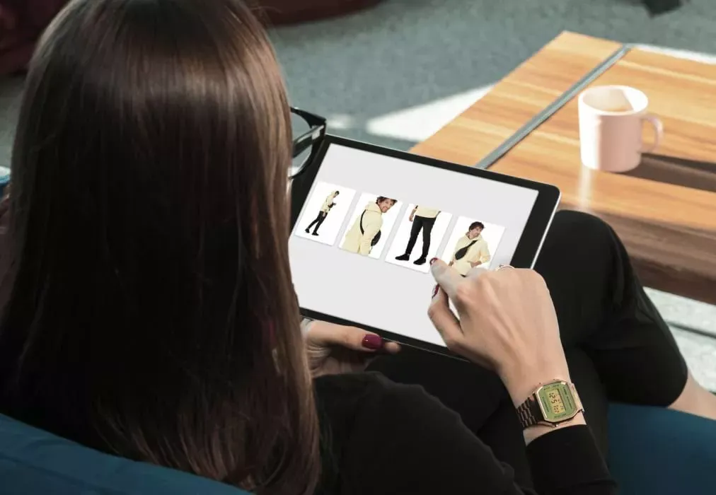 Woman Reviewing E-commerce Model Photos on Digital Tablet