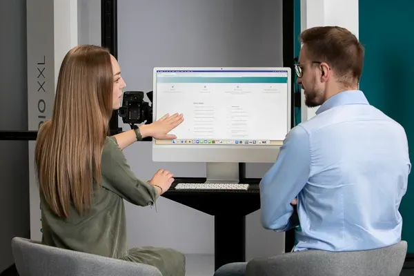 Two Colleagues Reviewing Software on Computer Monitor