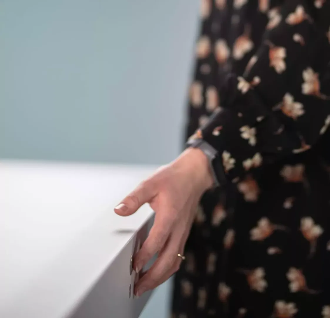 Detail of Hand Touching Clean White Photography Table Surface