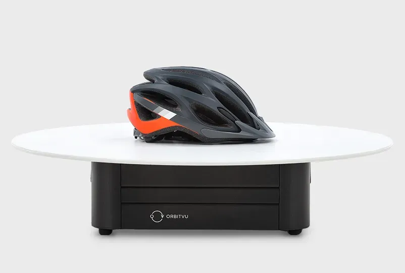 Dark Gray and Orange Bicycle Helmet on Orbitvu Product Turntable