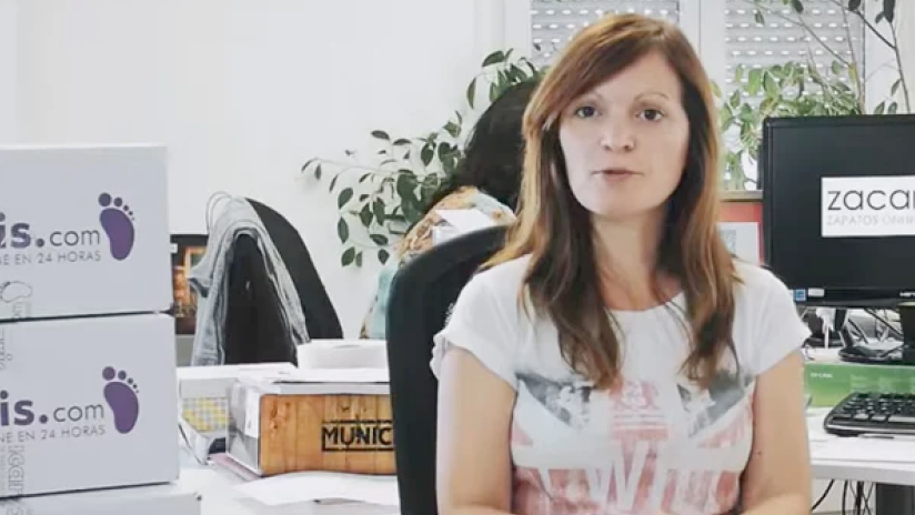 Woman in office setting speaking to camera