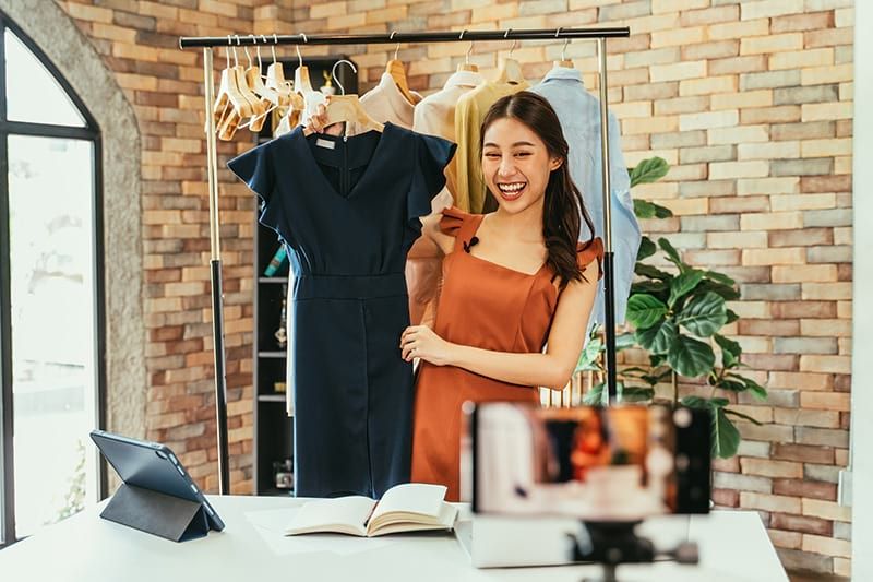shoppertainment smiling girl holding dress