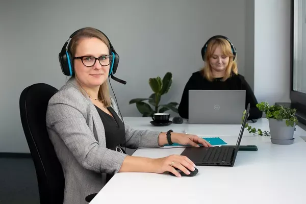  Two Customer Service Agents Working in Office 