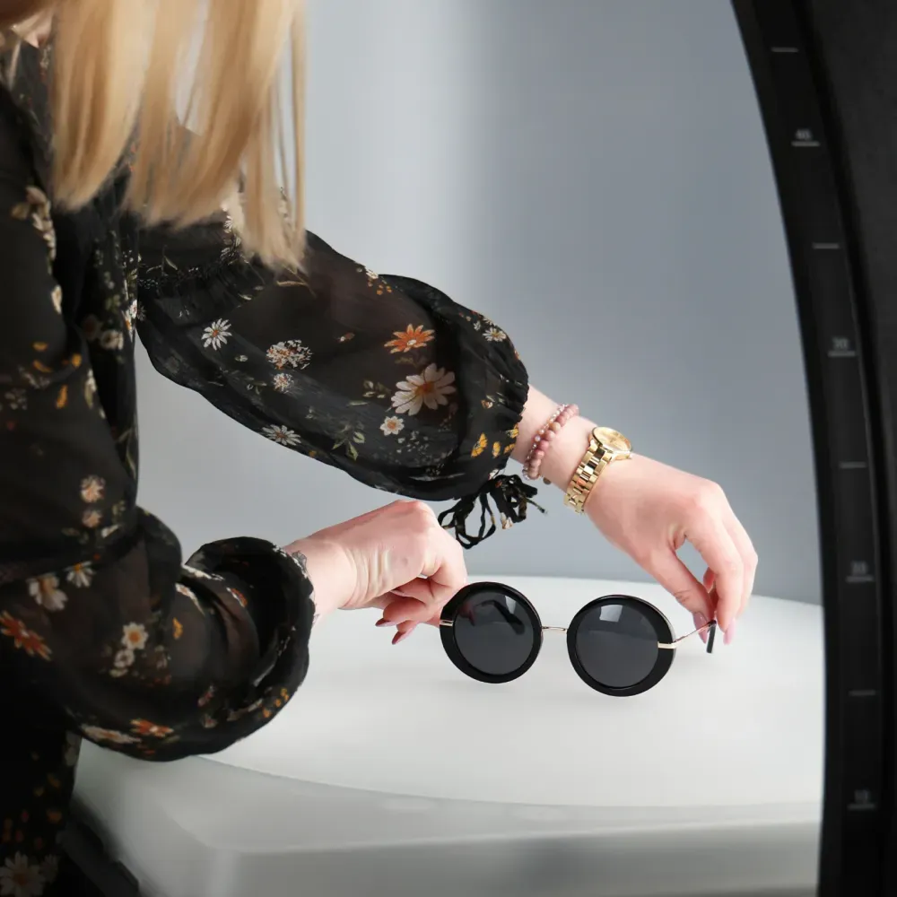 Woman Arranging Round Sunglasses for Product Photo Shoot