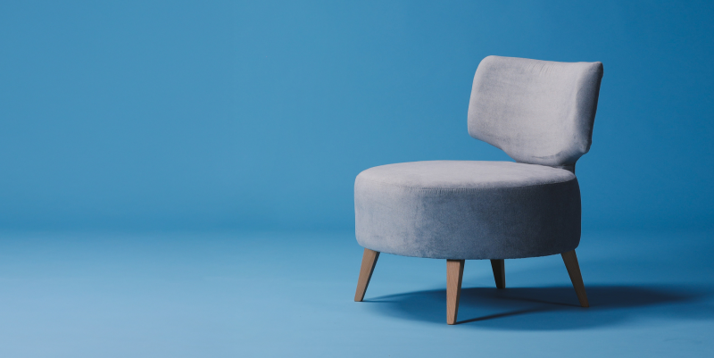 A photo of sofa chair on light blue background
