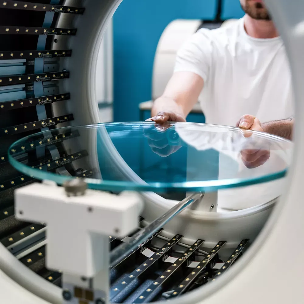 Technician Placing Glass Turntable in Automated Photo Studio