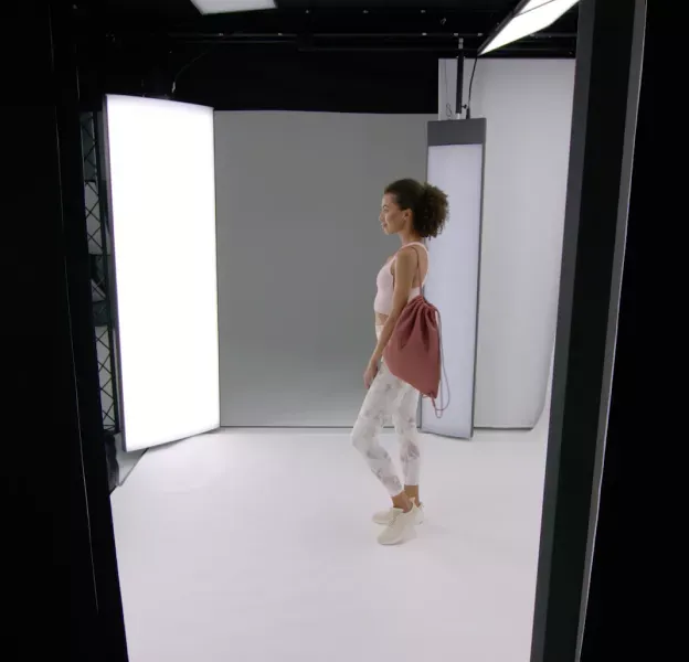 Fitness Model in Activewear Posing in Professional Photo Booth