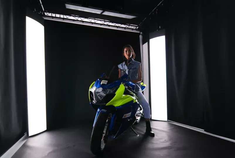 Female Model on Sport Motorcycle in Dark Studio