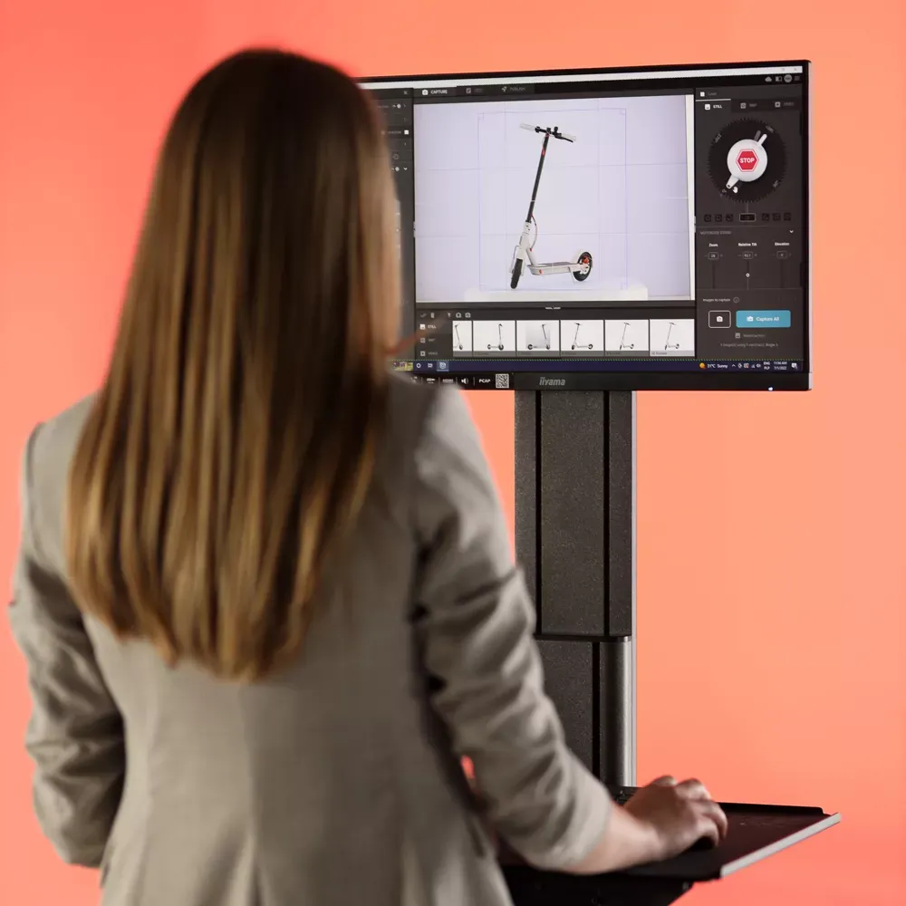 E-commerce Photographer Editing Scooter Image on Monitor