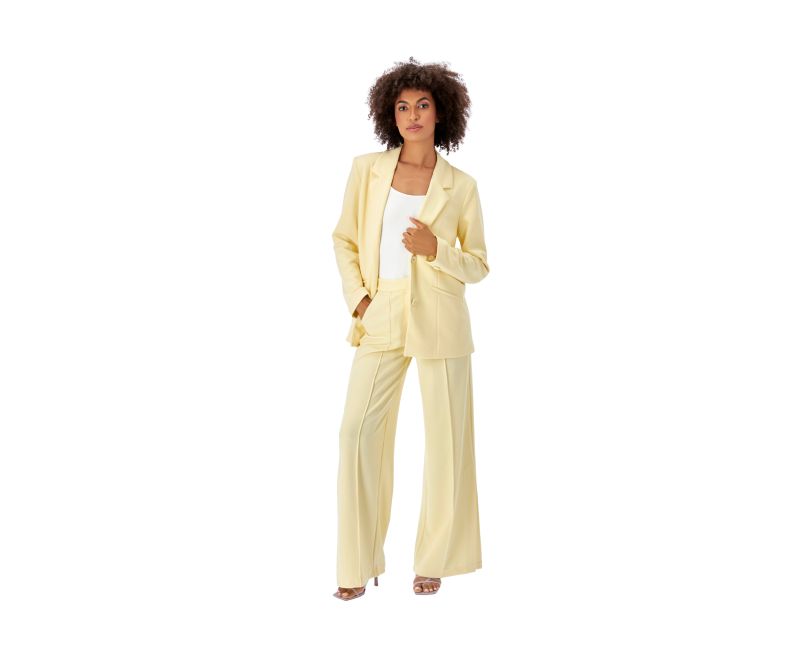 Woman in Pale Yellow Suit with Wide-Leg Trousers