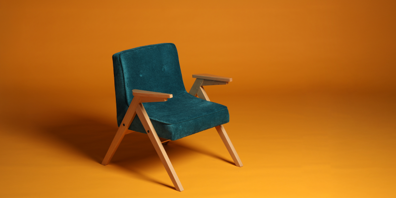 5 common reasons for e-commerce returns Stylish turquoise chair shot on a yellow background