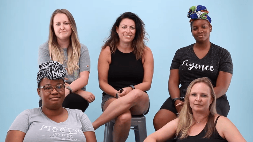 Group of Diverse Women Posing Against Blue Background