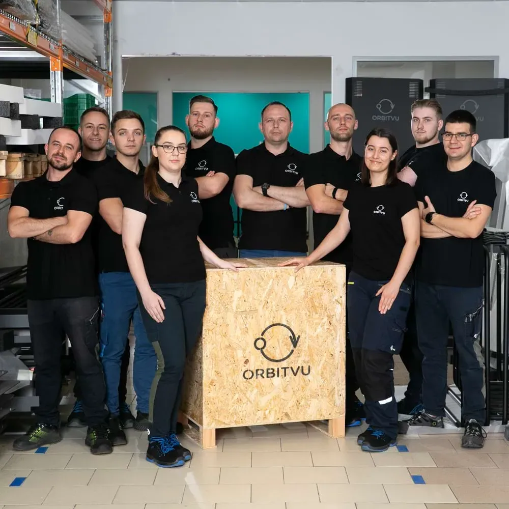     Title: Orbitvu Production and Logistics Team Posing with Branded Wooden Crate