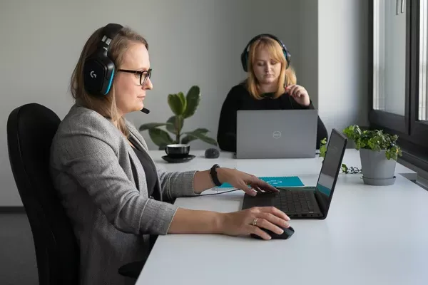 Two Customer Support Agents Working at Desks
