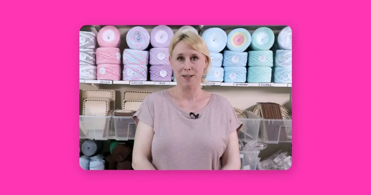 Woman standing before crochet and knitting supplies