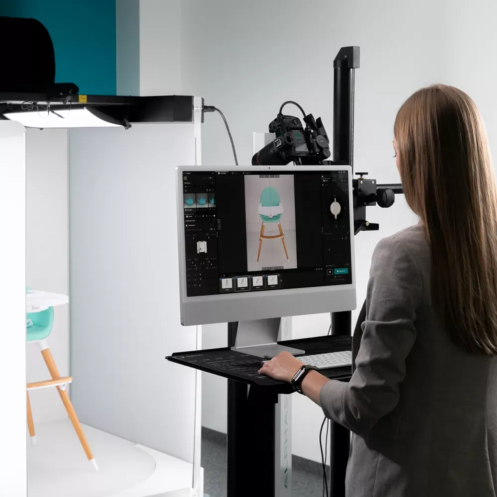 Product Photographer Post-Processing Baby High Chair Image on Computer