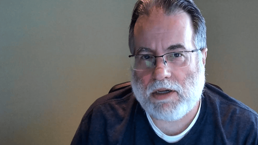 Middle Aged Man with Grey Beard and Glasses Headshot