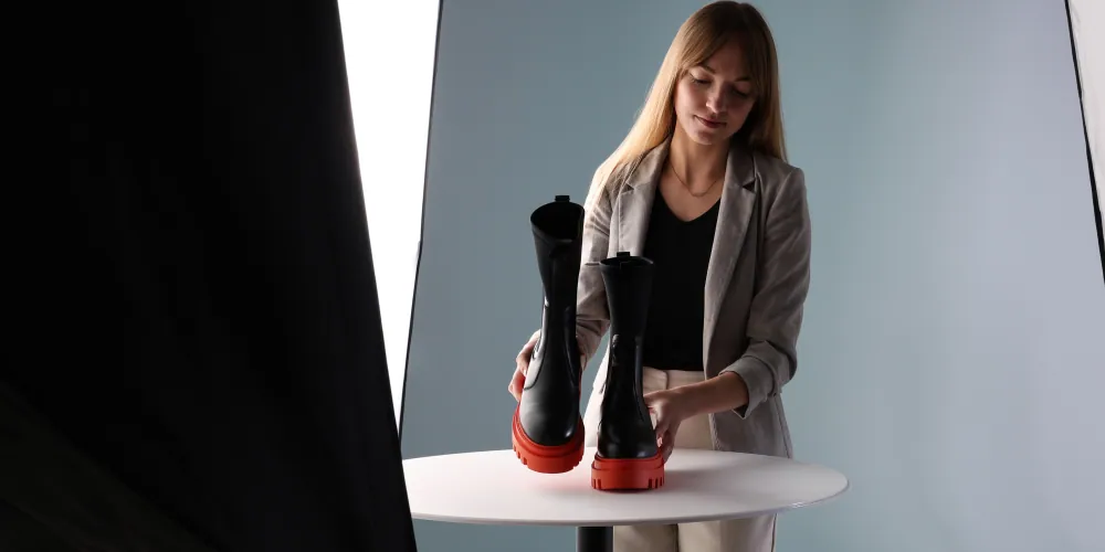 Woman placing rain shoes on the Orbitvu Turntable