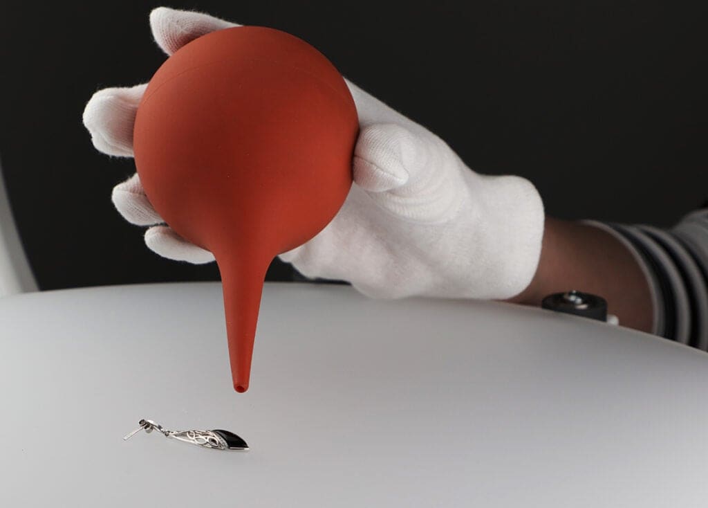 Preparation of jewelry for product photography – removing dust