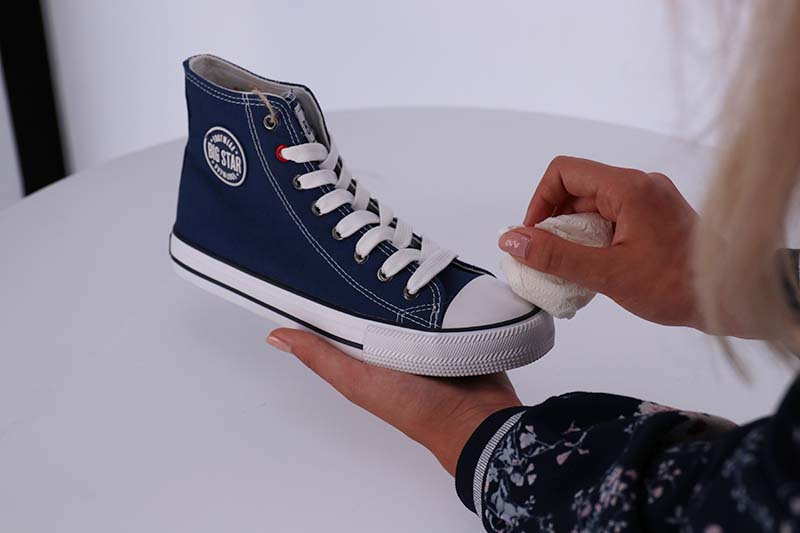 Cleaning a shoe for a photo session
