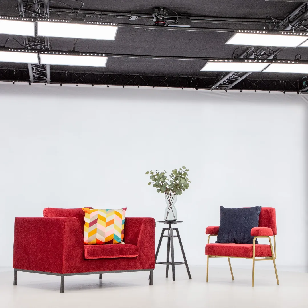 Modern red armchairs and side table in professional photo studio
