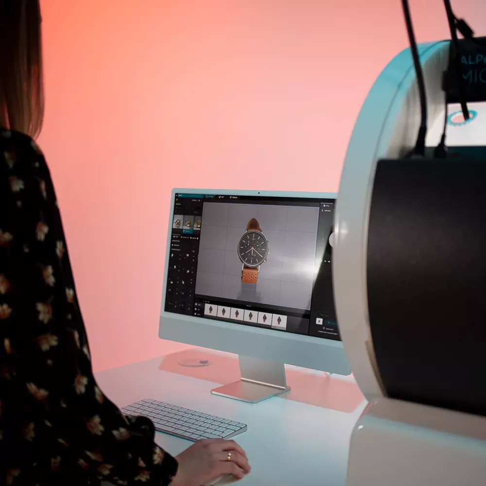 Woman photographing watch with computer software interface