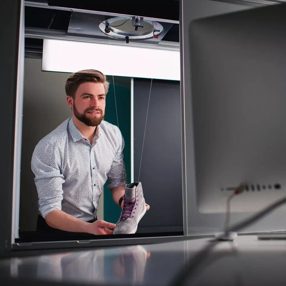 Man preparing product for professional shoe photography
